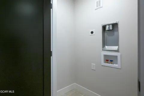 a bedroom with a bed and large window