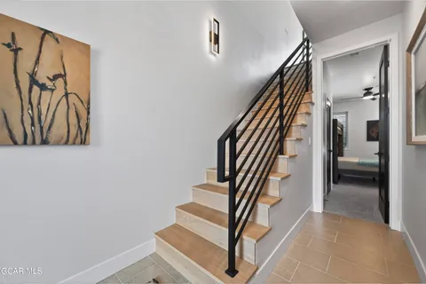 a view of entryway and hall with wooden floor