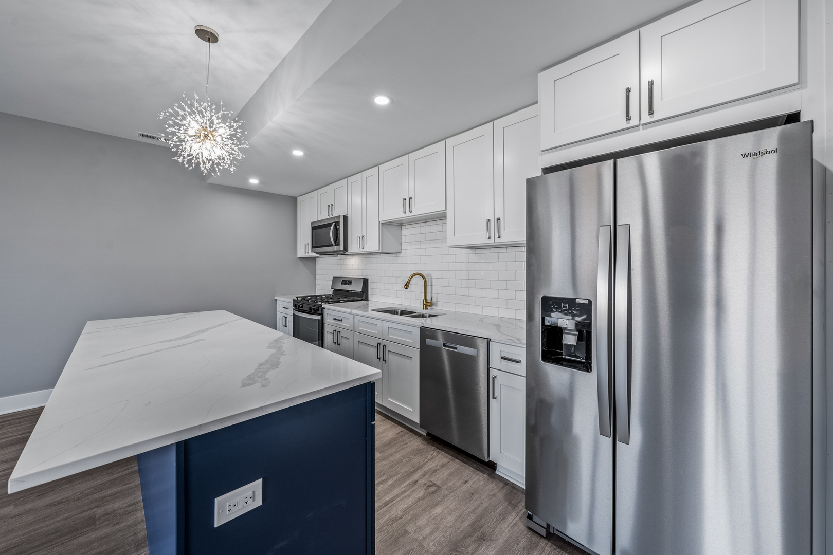 1416 8th Street, Unit 1416 Harvard, IL 60033 - Photo 14 of 19 a kitchen with kitchen island a counter space a sink appliances and cabinets
