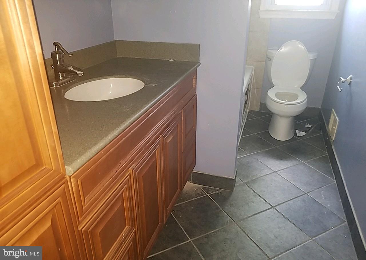 4618 Ballygar Road Baltimore, MD 21236 - Photo 14 of 29 a bathroom with a sink toilet and a mirror