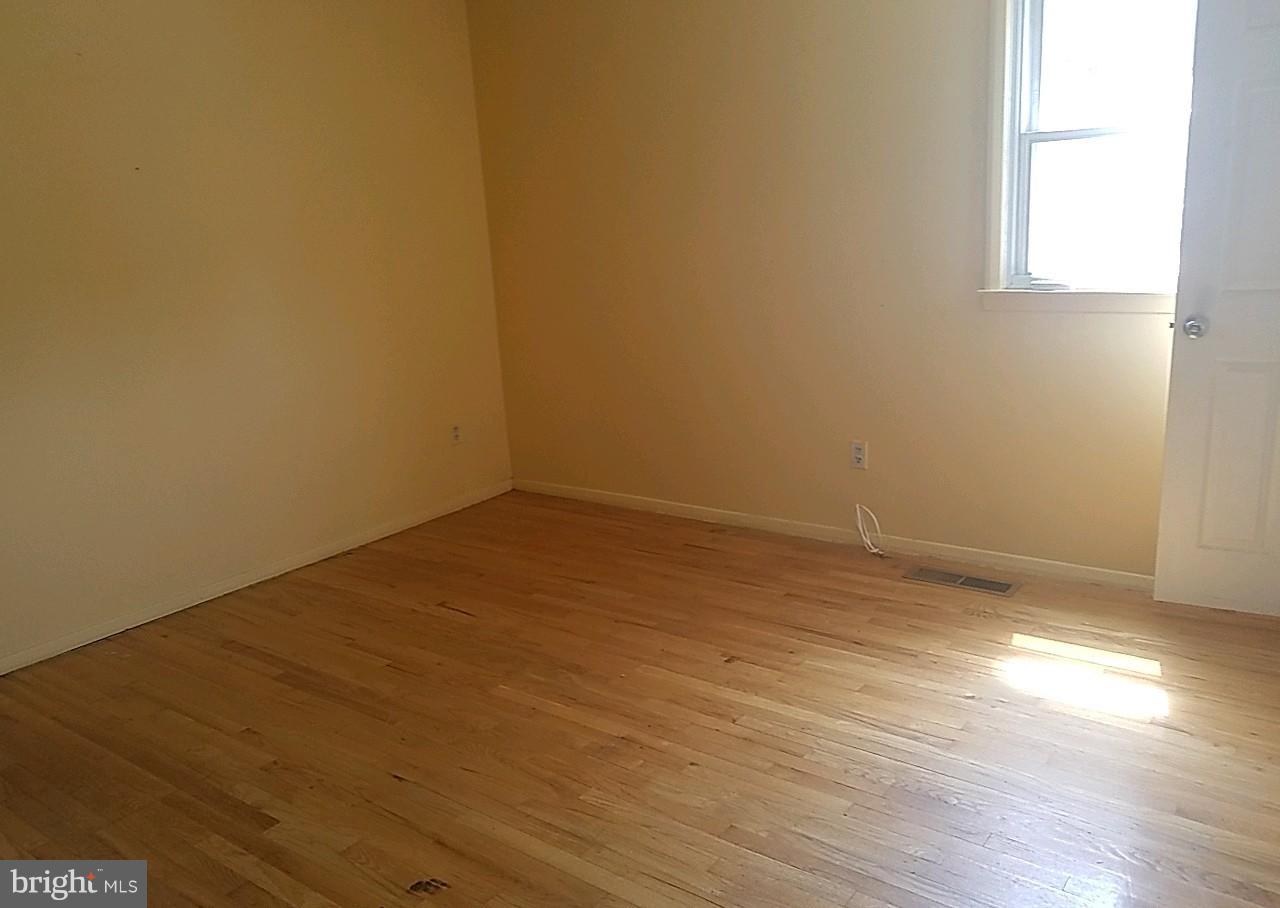 4618 Ballygar Road Baltimore, MD 21236 - Photo 19 of 29 an empty room with wooden floor and windows