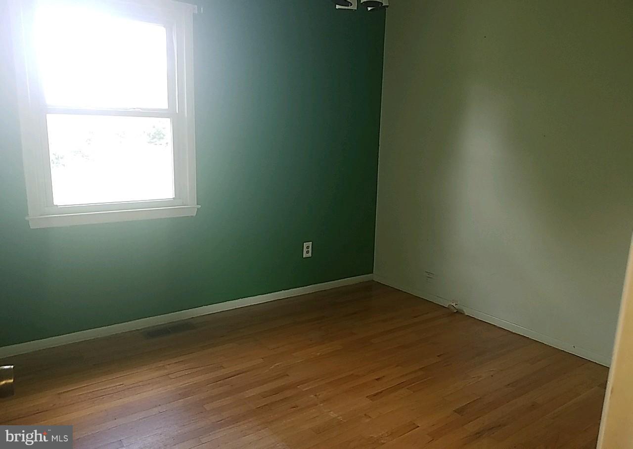 4618 Ballygar Road Baltimore, MD 21236 - Photo 23 of 29 an empty room with wooden floor and windows