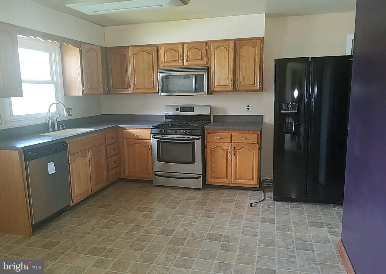 4618 Ballygar Road Baltimore, MD 21236 - Photo 4 of 29 a kitchen with stainless steel appliances granite countertop a stove a refrigerator and a sink