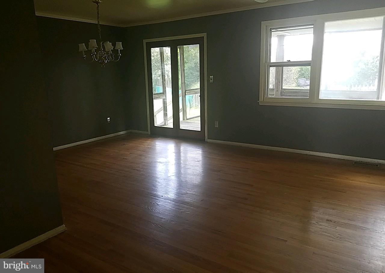 4618 Ballygar Road Baltimore, MD 21236 - Photo 5 of 29 an empty room with wooden floor and windows