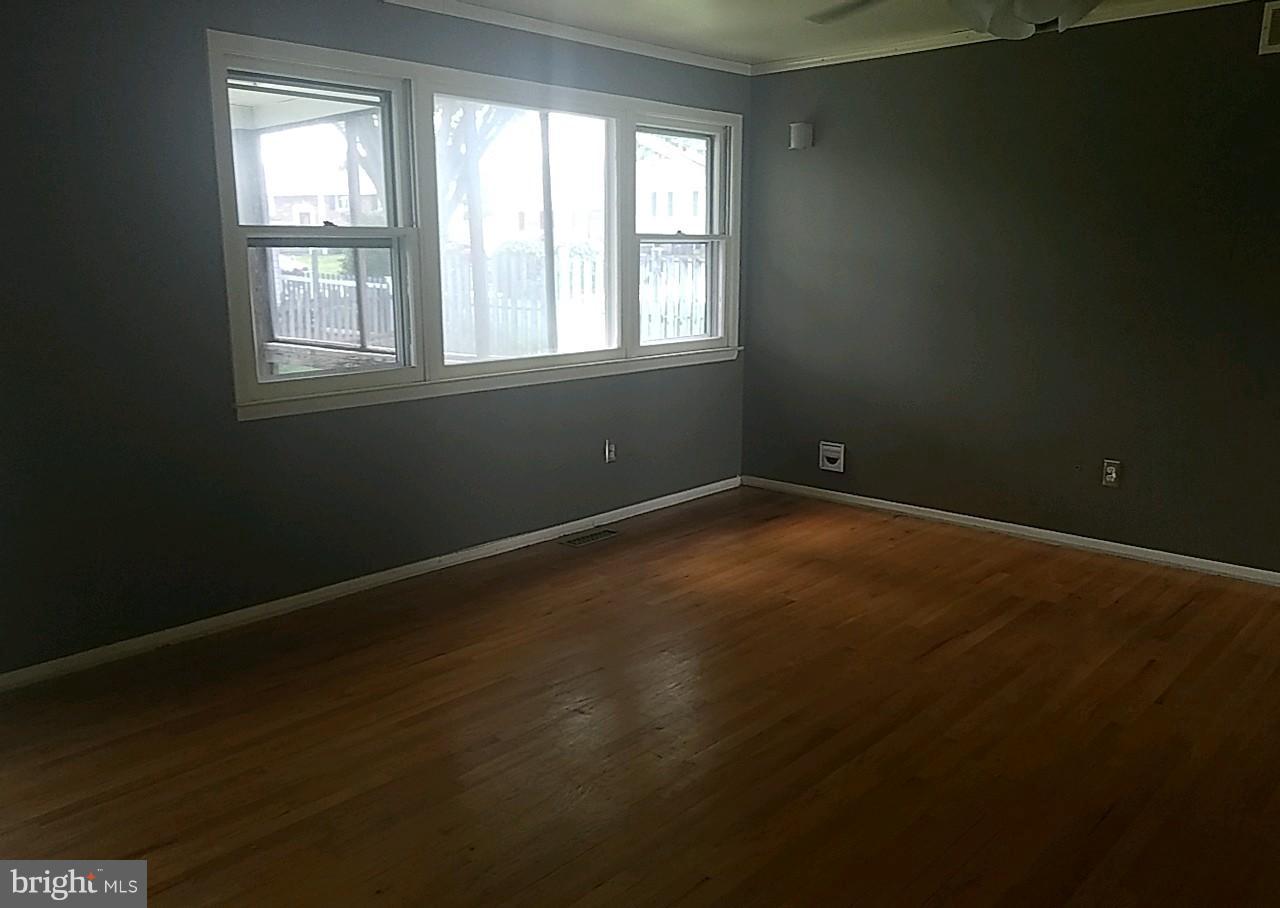 4618 Ballygar Road Baltimore, MD 21236 - Photo 7 of 29 a view of an empty room with wooden floor and a window