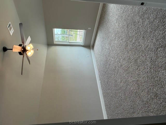 6428 Raleigh Loop College Station, TX 77845 - Photo 14 of 20 an empty room with windows chandelier fan and windows