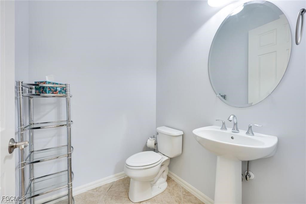 11758 Izarra Way, Unit 7703 Fort Myers, FL 33912 - Photo 16 of 37 a bathroom with a sink toilet and mirror