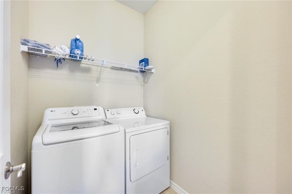 11758 Izarra Way, Unit 7703 Fort Myers, FL 33912 - Photo 17 of 37 a view of storage and utility room with washer and dryer