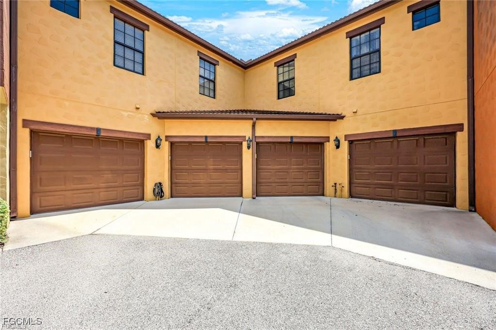 11758 Izarra Way, Unit 7703 Fort Myers, FL 33912 - Photo 19 of 37 a house with a outdoor space