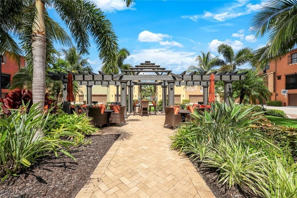 11758 Izarra Way, Unit 7703 Fort Myers, FL 33912 - Photo 20 of 37 a view of a yard with plants