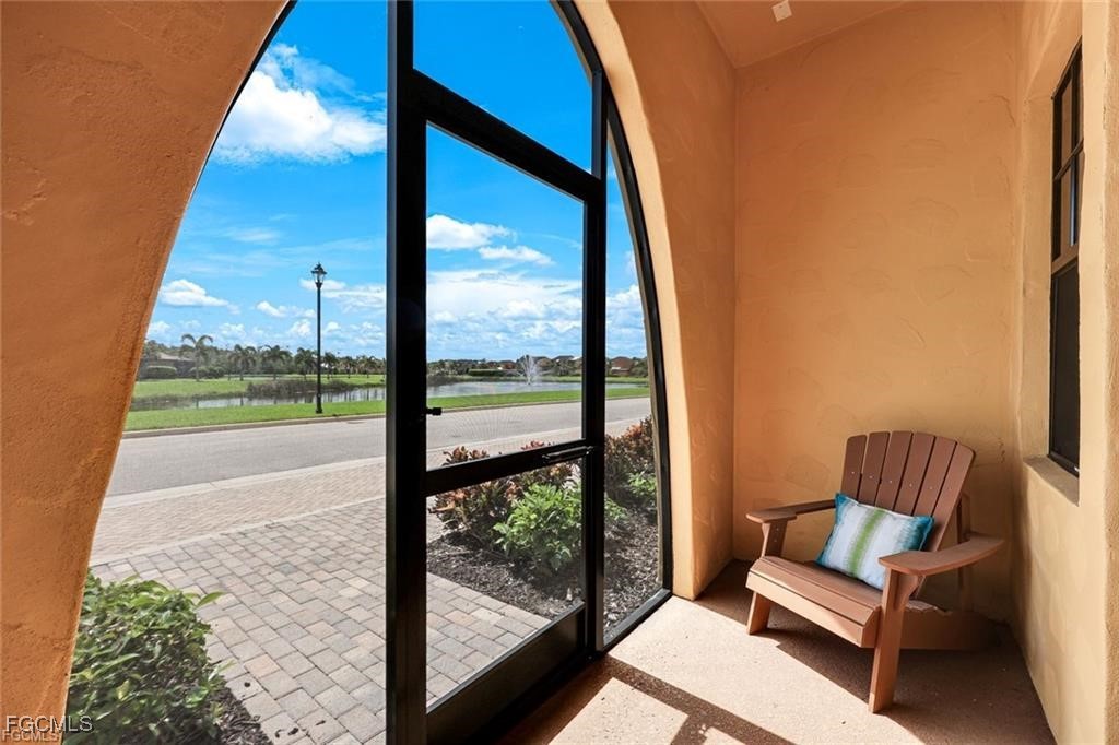 11758 Izarra Way, Unit 7703 Fort Myers, FL 33912 - Photo 2 of 37 a view of a living room and floor to ceiling window