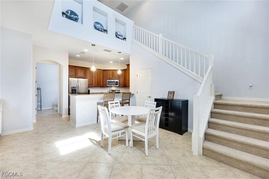 11758 Izarra Way, Unit 7703 Fort Myers, FL 33912 - Photo 3 of 37 a view of a dining room with furniture