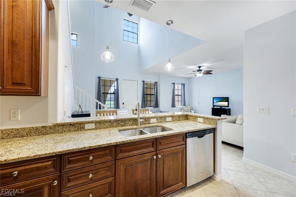 11758 Izarra Way, Unit 7703 Fort Myers, FL 33912 - Photo 7 of 37 a bathroom with a granite countertop sink and a mirror