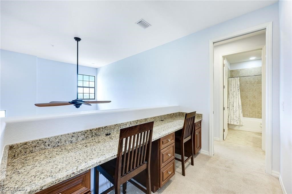 11758 Izarra Way, Unit 7703 Fort Myers, FL 33912 - Photo 9 of 37 a view of entryway and kitchen