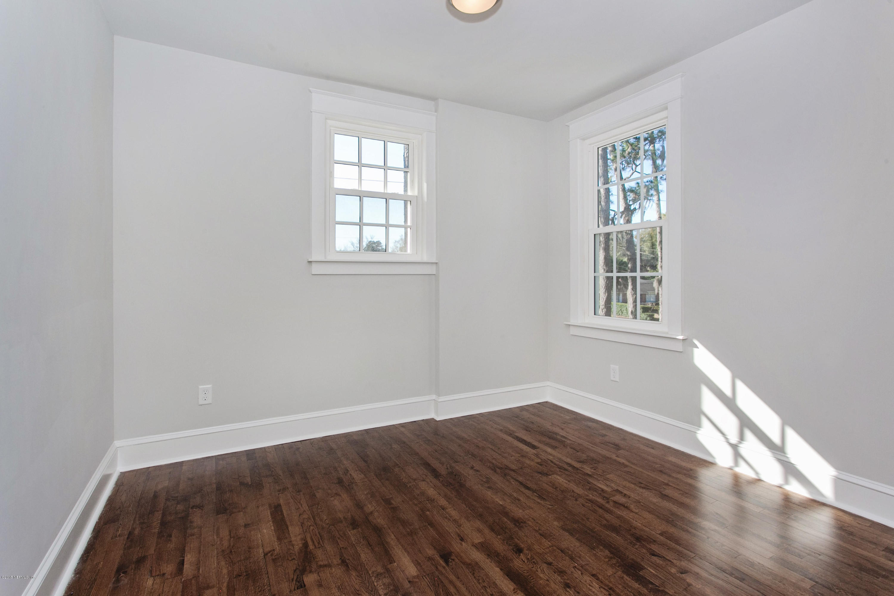 1639 Lorimier Road Jacksonville, FL 32207 - Photo 14 of 25 an empty room with wooden floor and windows