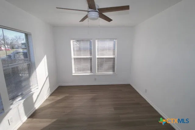 wooden floor in an empty room with a window