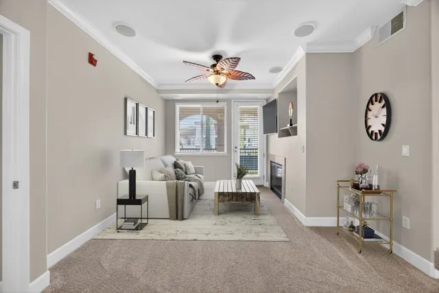 a living room with furniture a chandelier and a window