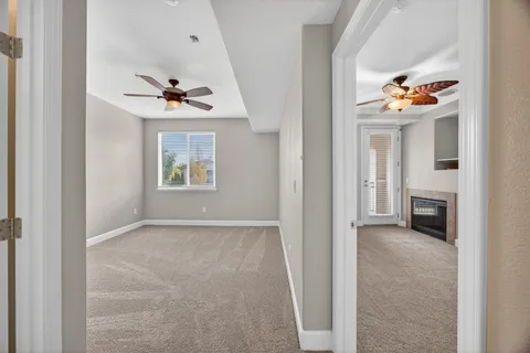 a view of an empty room with a fireplace and a window