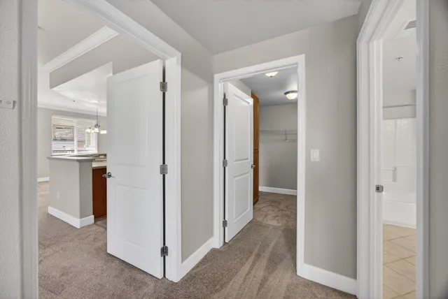 a view of a hallway with wooden floor