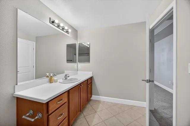 a view of a hallway to rooms