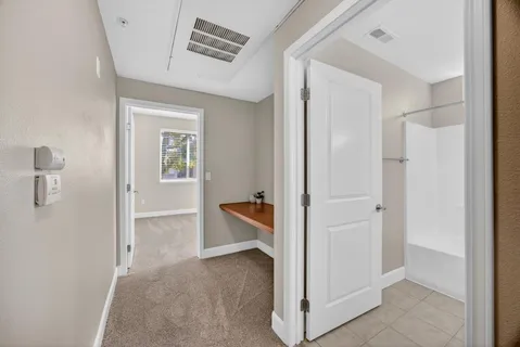 a bedroom with a bed and a potted plant
