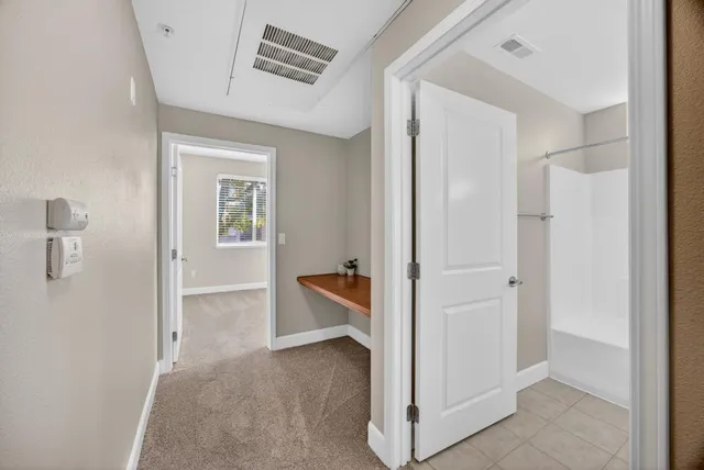 a bedroom with a bed and a potted plant