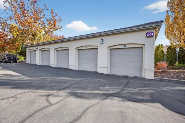 an aerial view of residential houses with outdoor space and parking