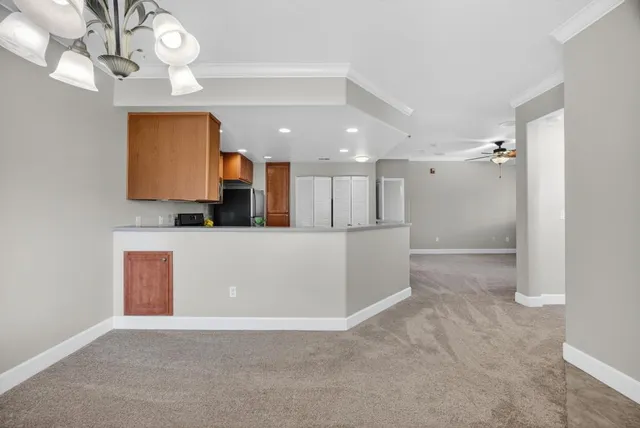 a view of a kitchen with a microwave and a chandelier