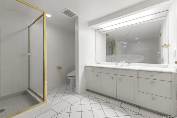 a spacious bathroom with a granite countertop sink mirror and toilet