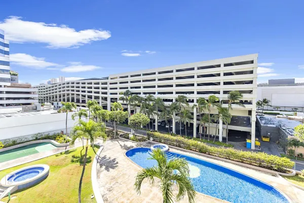 a view of a swimming pool with a patio and city view