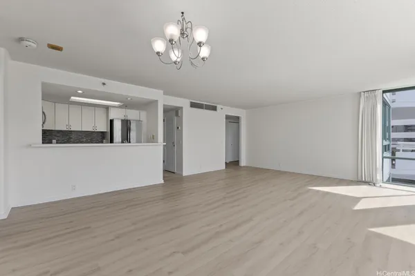 a view of a kitchen with wooden floor and a kitchen