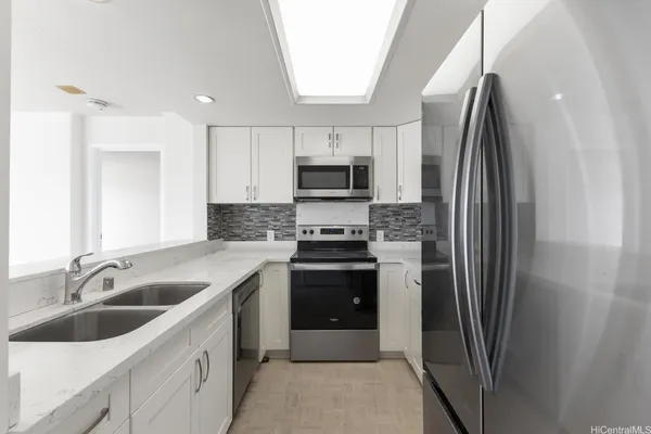 a kitchen with a sink and a refrigerator