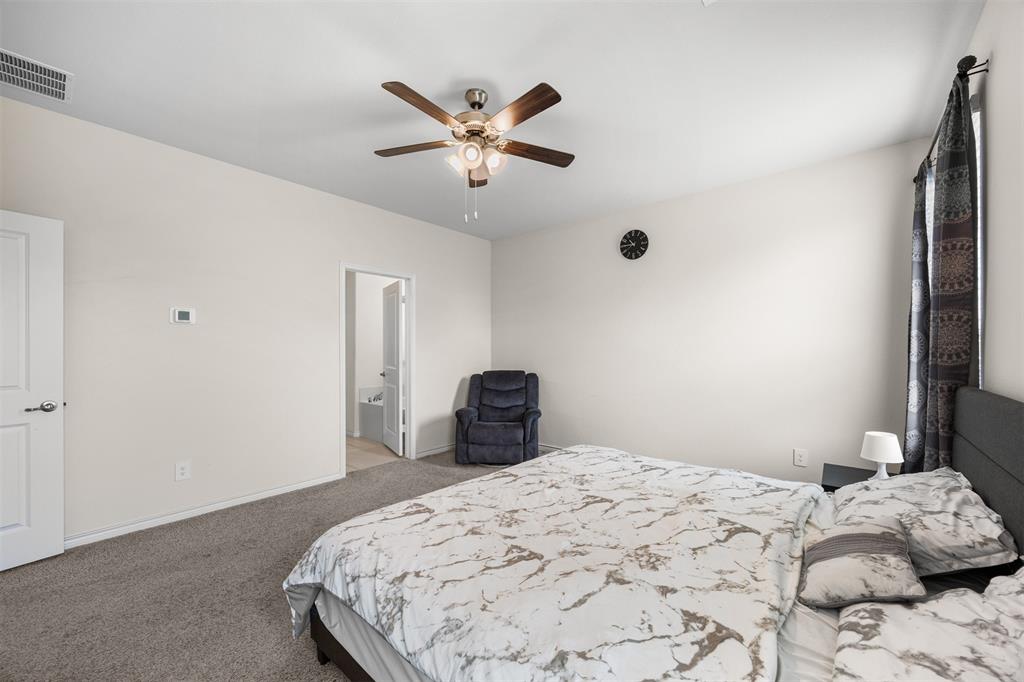 3808 High Country Road Aubrey, TX 76227 - Photo 16 of 36 Spacious room featuring neutral carpeting, light wall tones, and a ceiling fan with integrated lighting