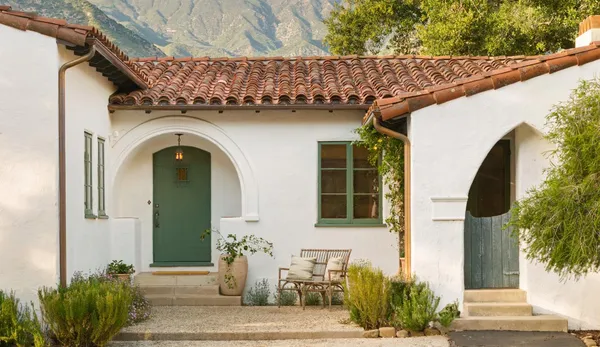 a front view of a house with outdoor seating