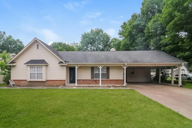 a front view of house with yard and green space