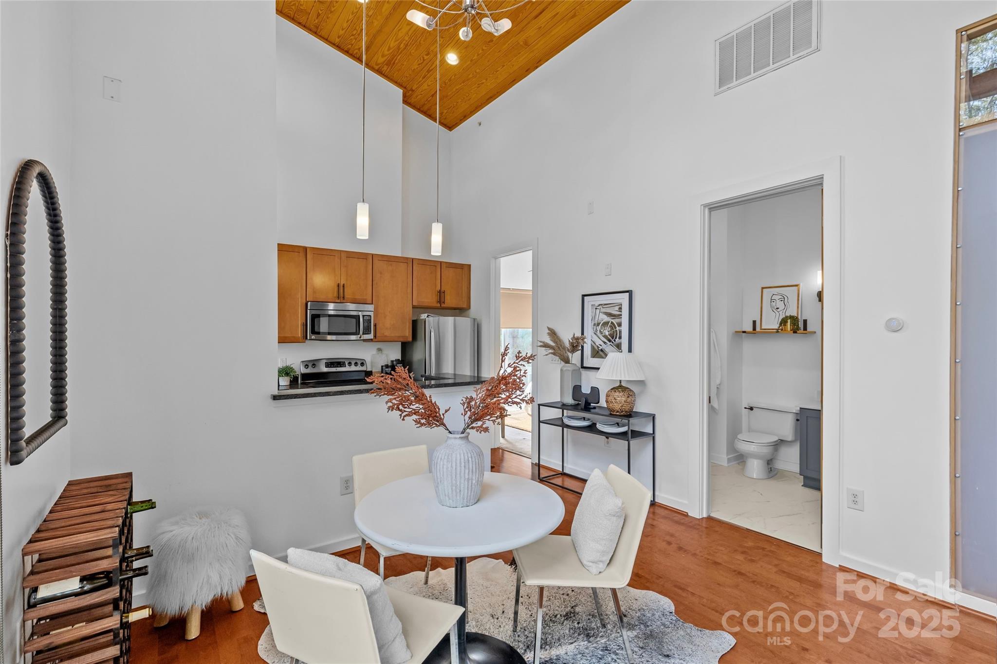 2116 McClintock Road, Unit 232 Charlotte, NC 28205 - Photo 12 of 48 a dining room with furniture and wooden floor