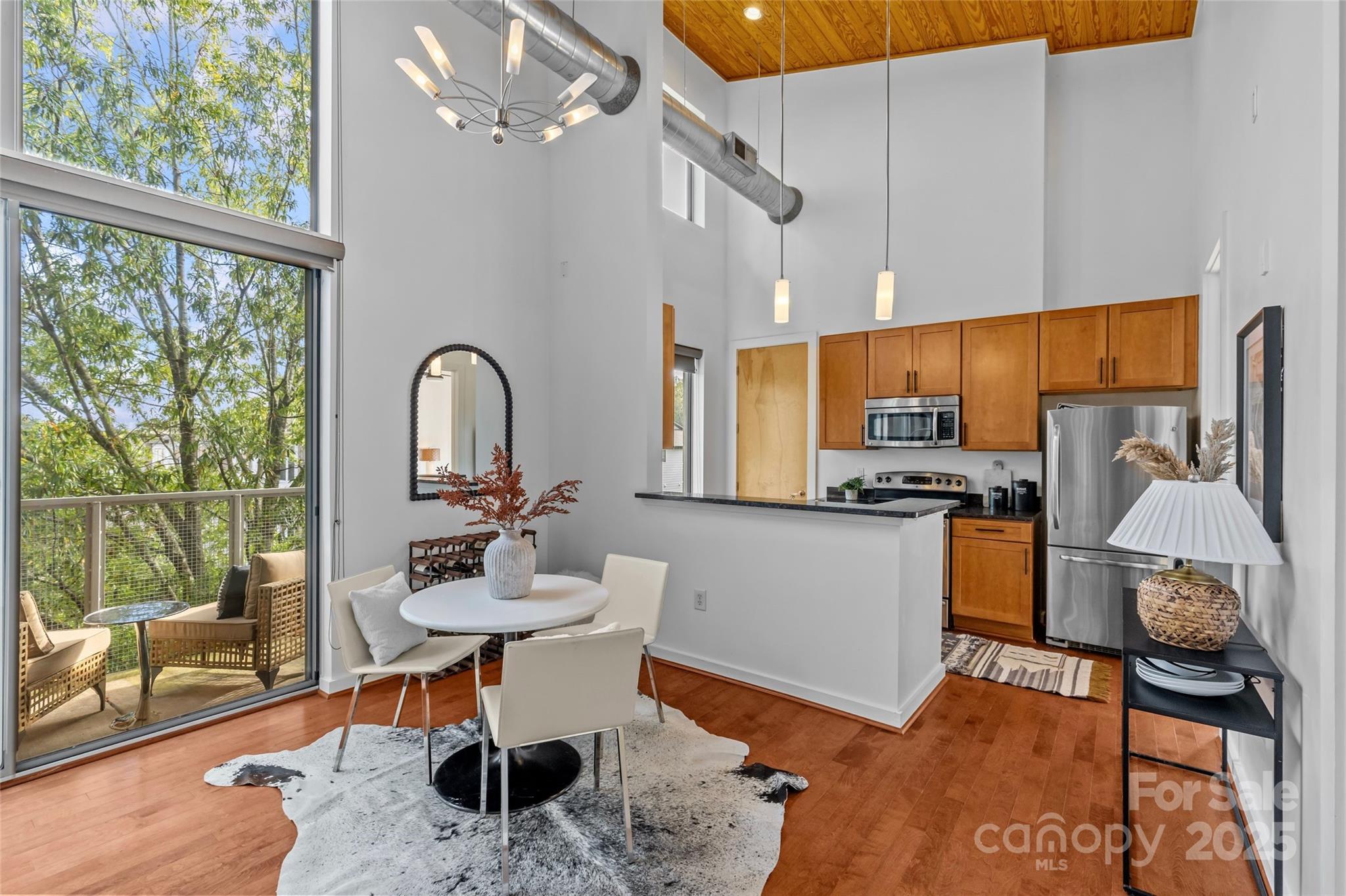 2116 McClintock Road, Unit 232 Charlotte, NC 28205 - Photo 14 of 48 a kitchen with a table chairs refrigerator and sink