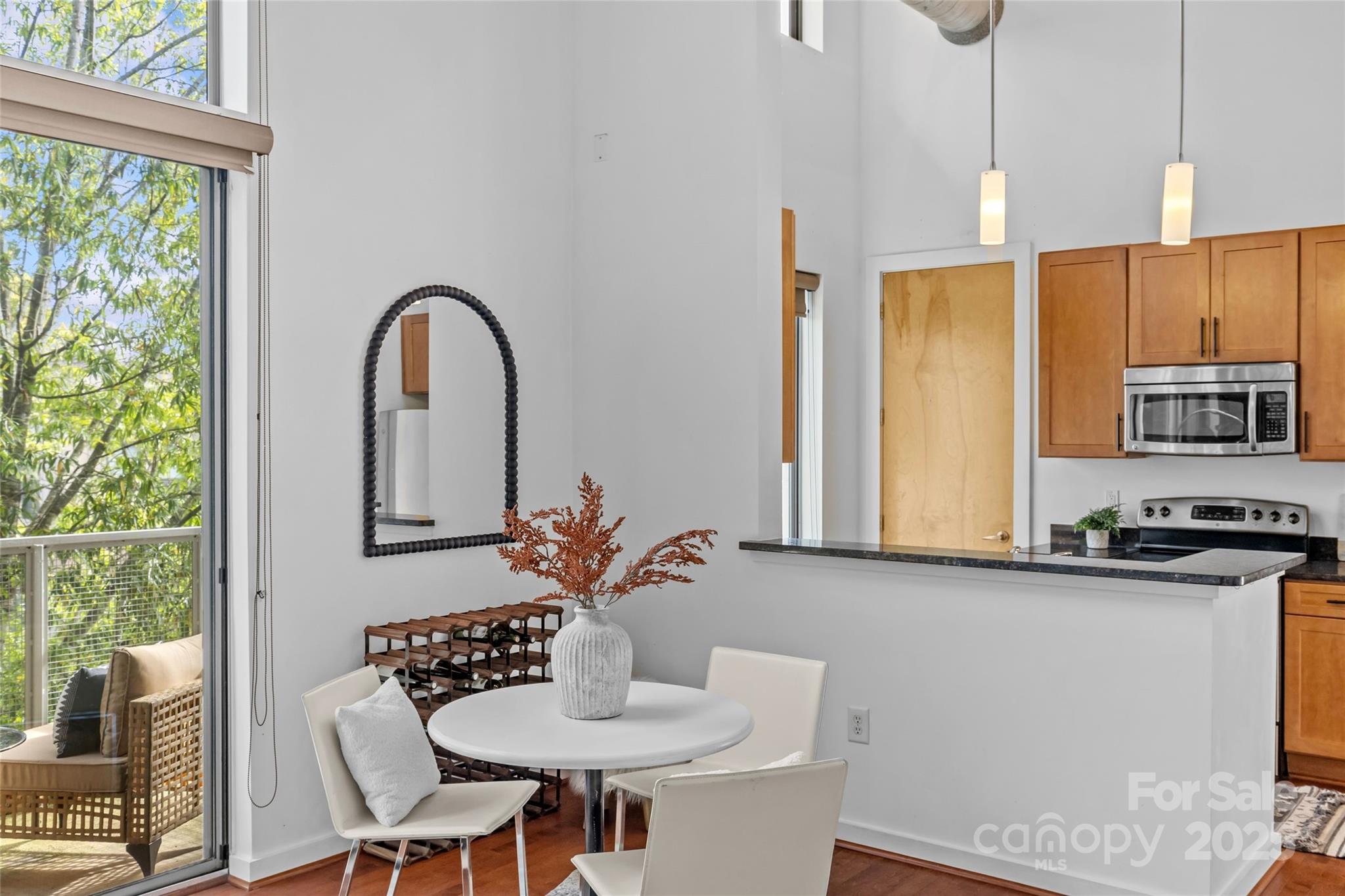 2116 McClintock Road, Unit 232 Charlotte, NC 28205 - Photo 16 of 48 a kitchen with a table chairs stove and cabinets