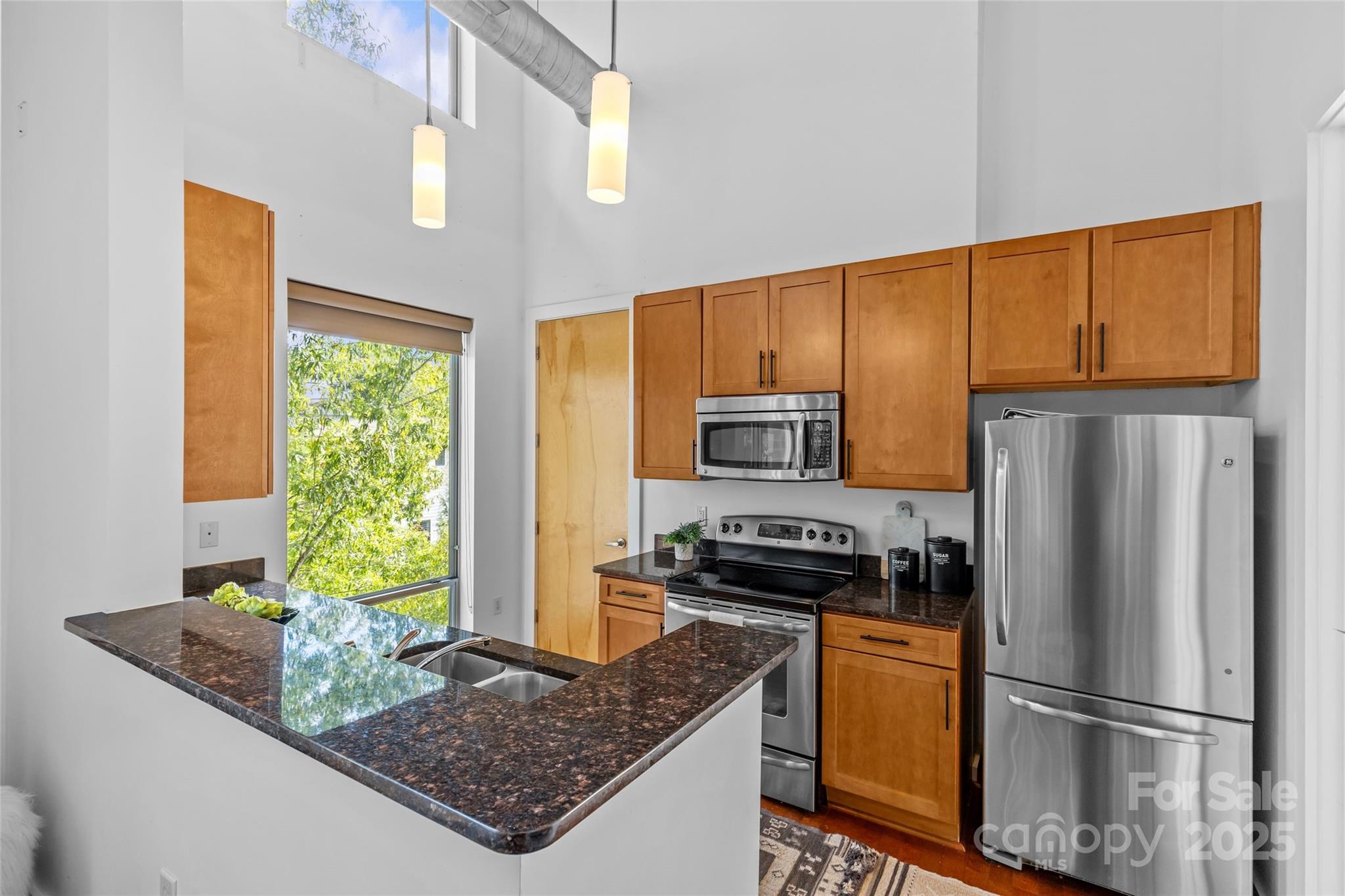 2116 McClintock Road, Unit 232 Charlotte, NC 28205 - Photo 18 of 48 a kitchen with stainless steel appliances granite countertop a refrigerator a stove and a sink