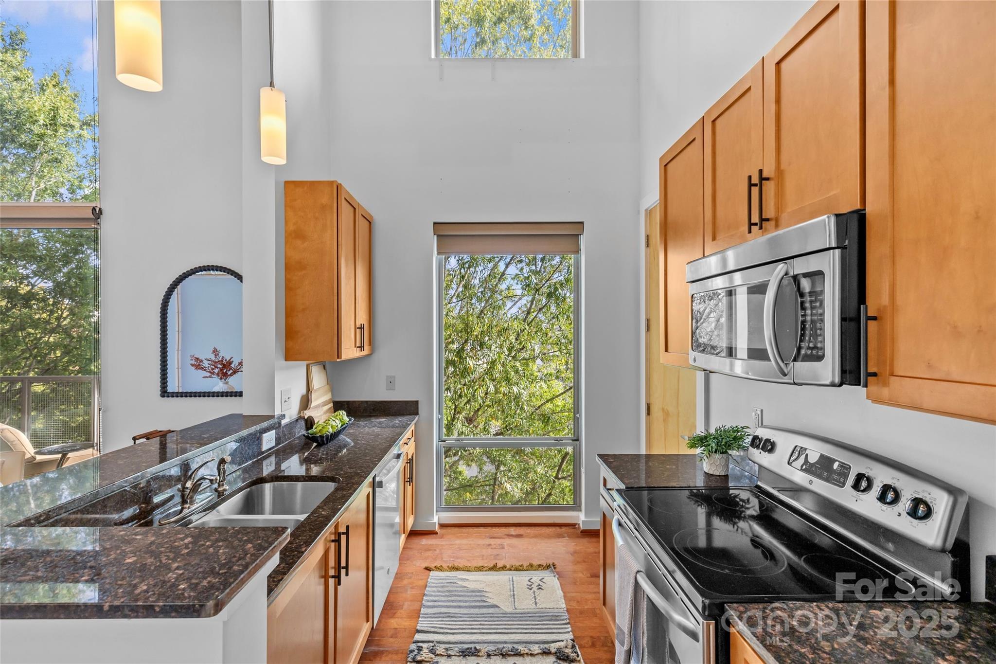2116 McClintock Road, Unit 232 Charlotte, NC 28205 - Photo 19 of 48 a kitchen with stainless steel appliances granite countertop a stove and a sink