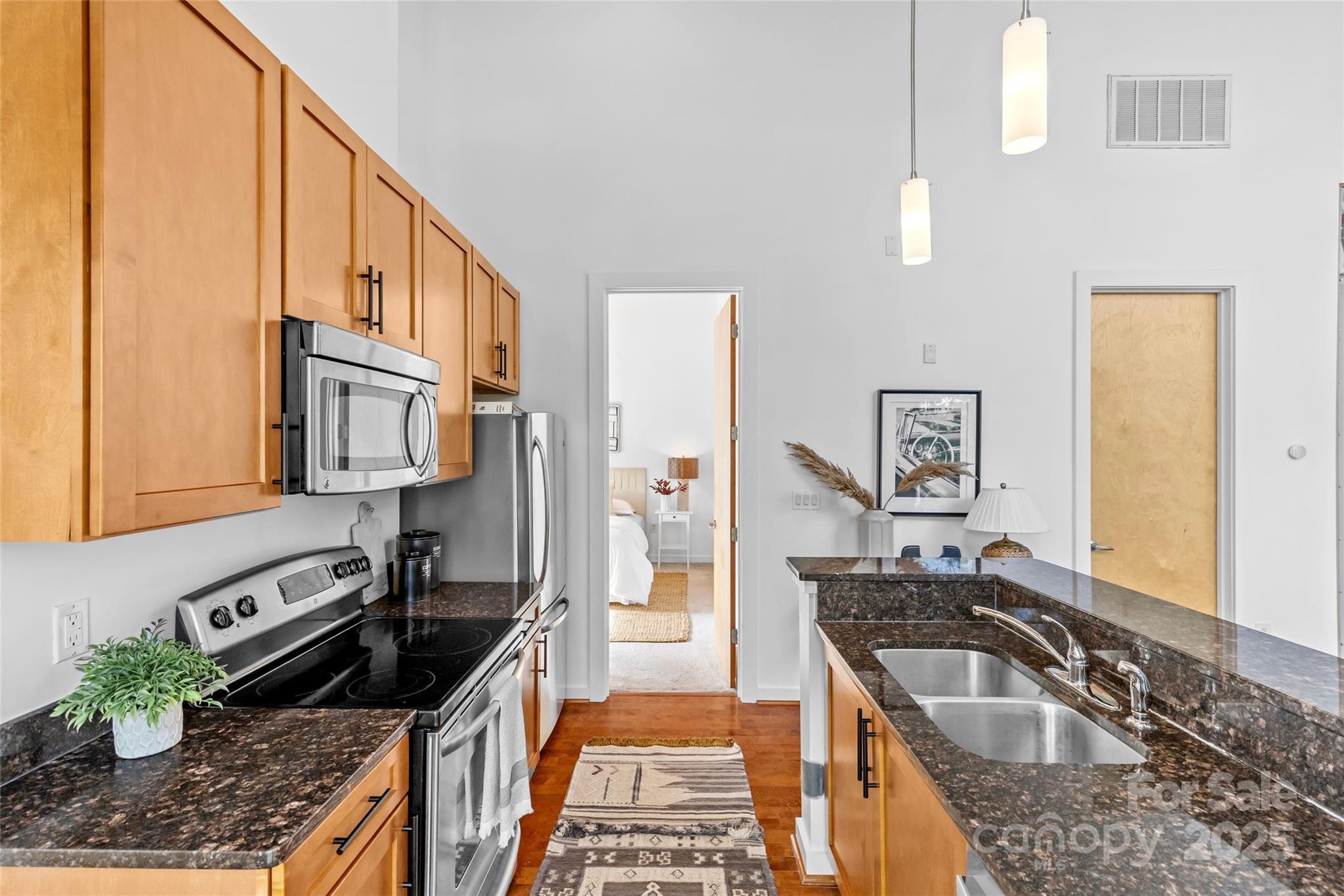 2116 McClintock Road, Unit 232 Charlotte, NC 28205 - Photo 20 of 48 a kitchen with granite countertop a stove a sink and a refrigerator