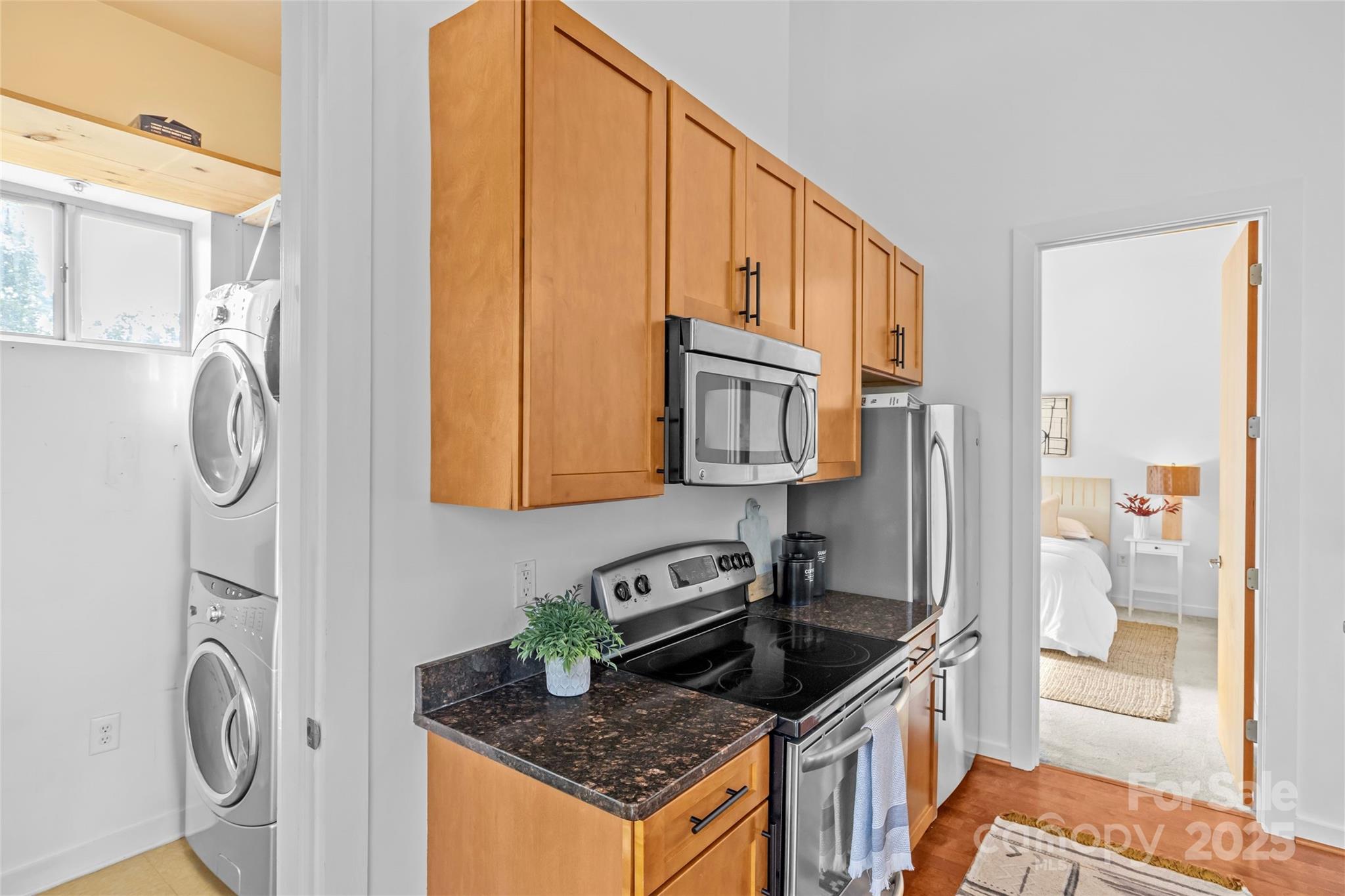 2116 McClintock Road, Unit 232 Charlotte, NC 28205 - Photo 22 of 48 a kitchen with stainless steel appliances granite countertop a stove a refrigerator and a cabinets