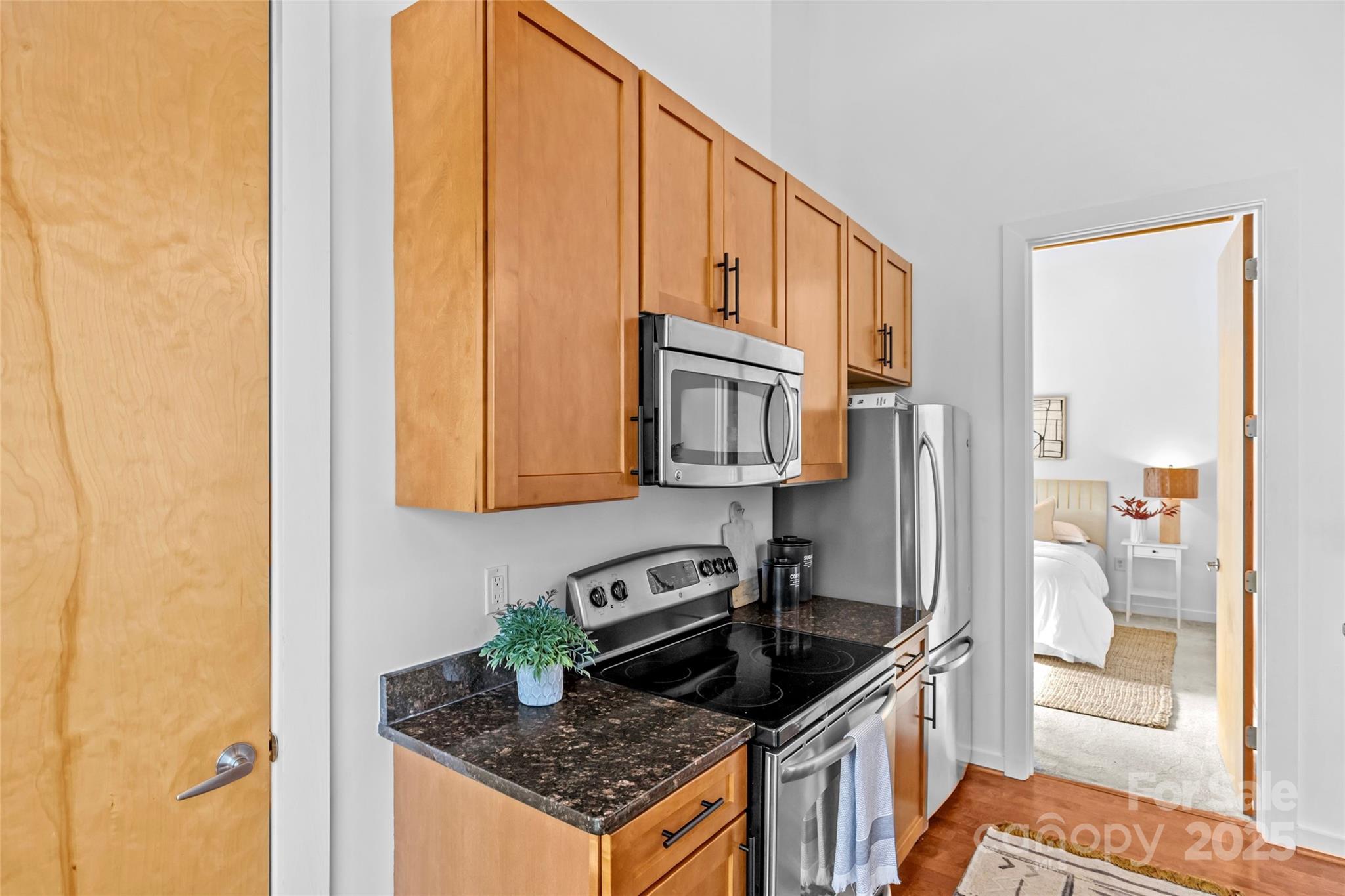 2116 McClintock Road, Unit 232 Charlotte, NC 28205 - Photo 23 of 48 a kitchen with stainless steel appliances granite countertop a stove a sink and a refrigerator
