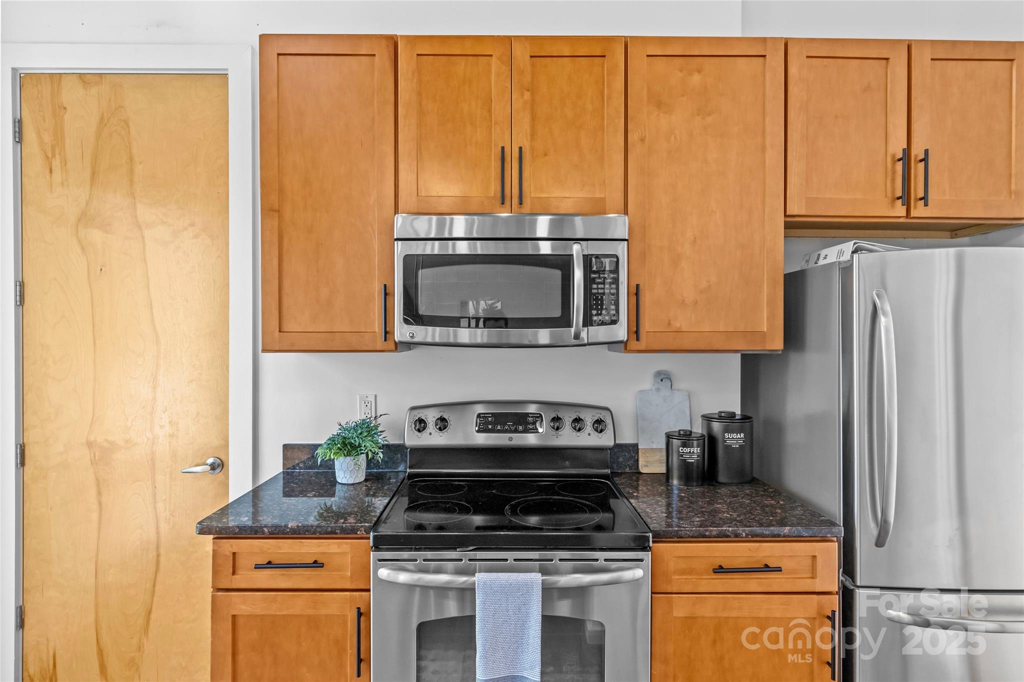 2116 McClintock Road, Unit 232 Charlotte, NC 28205 - Photo 25 of 48 a kitchen with stainless steel appliances granite countertop a stove a sink and a microwave
