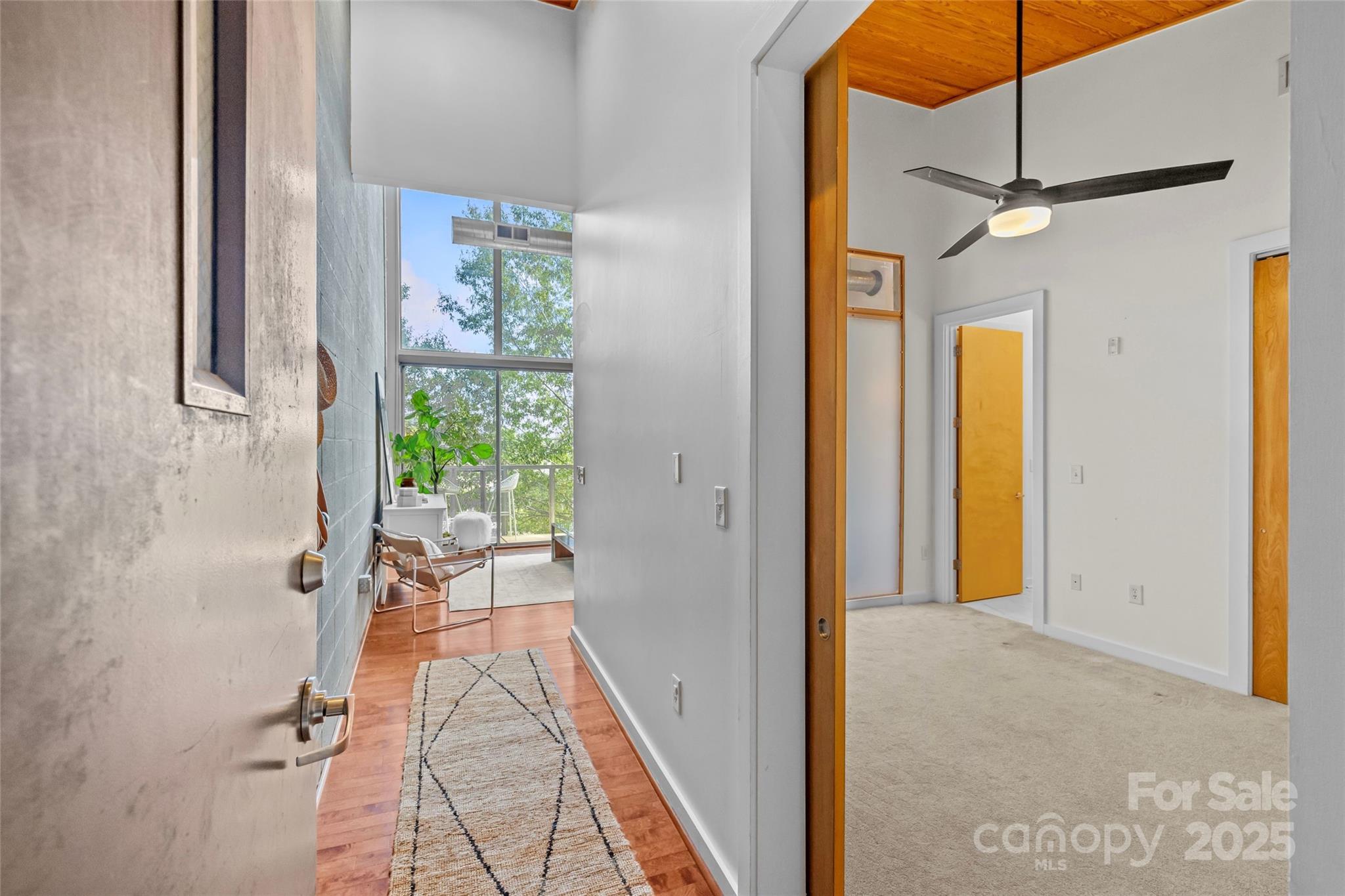 2116 McClintock Road, Unit 232 Charlotte, NC 28205 - Photo 3 of 48 a view of a hallway with a dining table & chairs