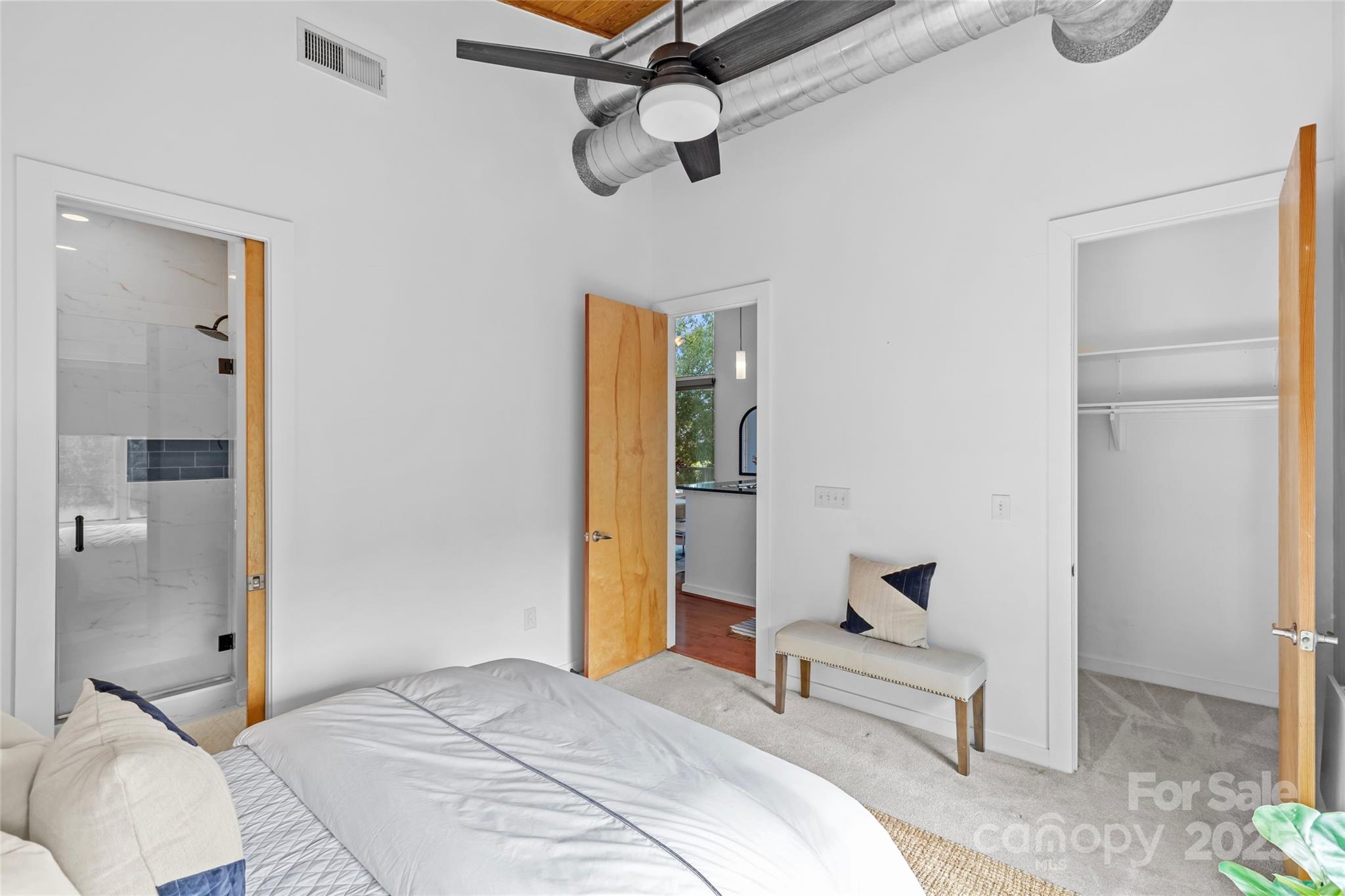 2116 McClintock Road, Unit 232 Charlotte, NC 28205 - Photo 32 of 48 a bedroom with a bed and a chandelier