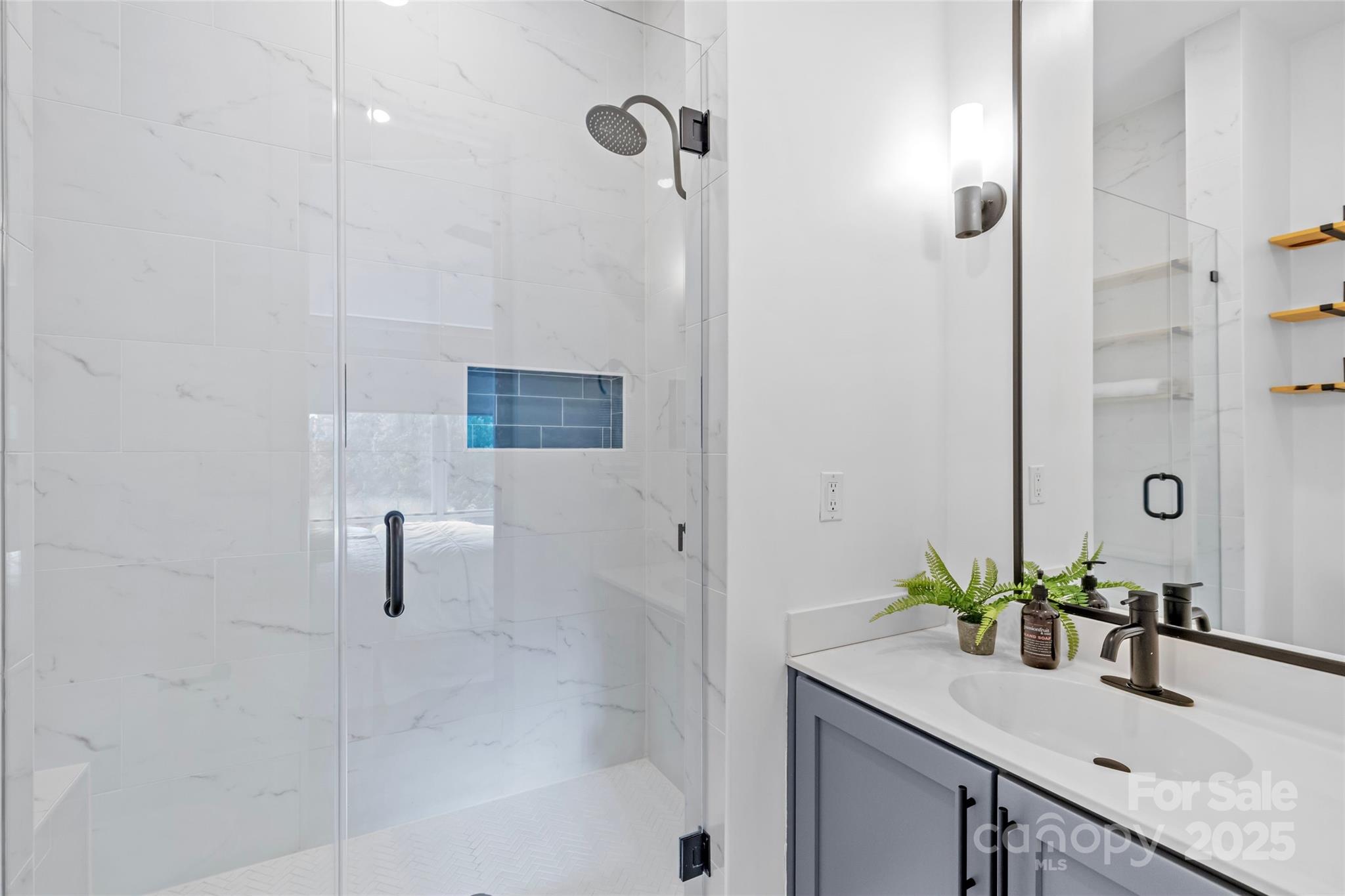 2116 McClintock Road, Unit 232 Charlotte, NC 28205 - Photo 34 of 48 a bathroom with a granite countertop shower a sink and a mirror