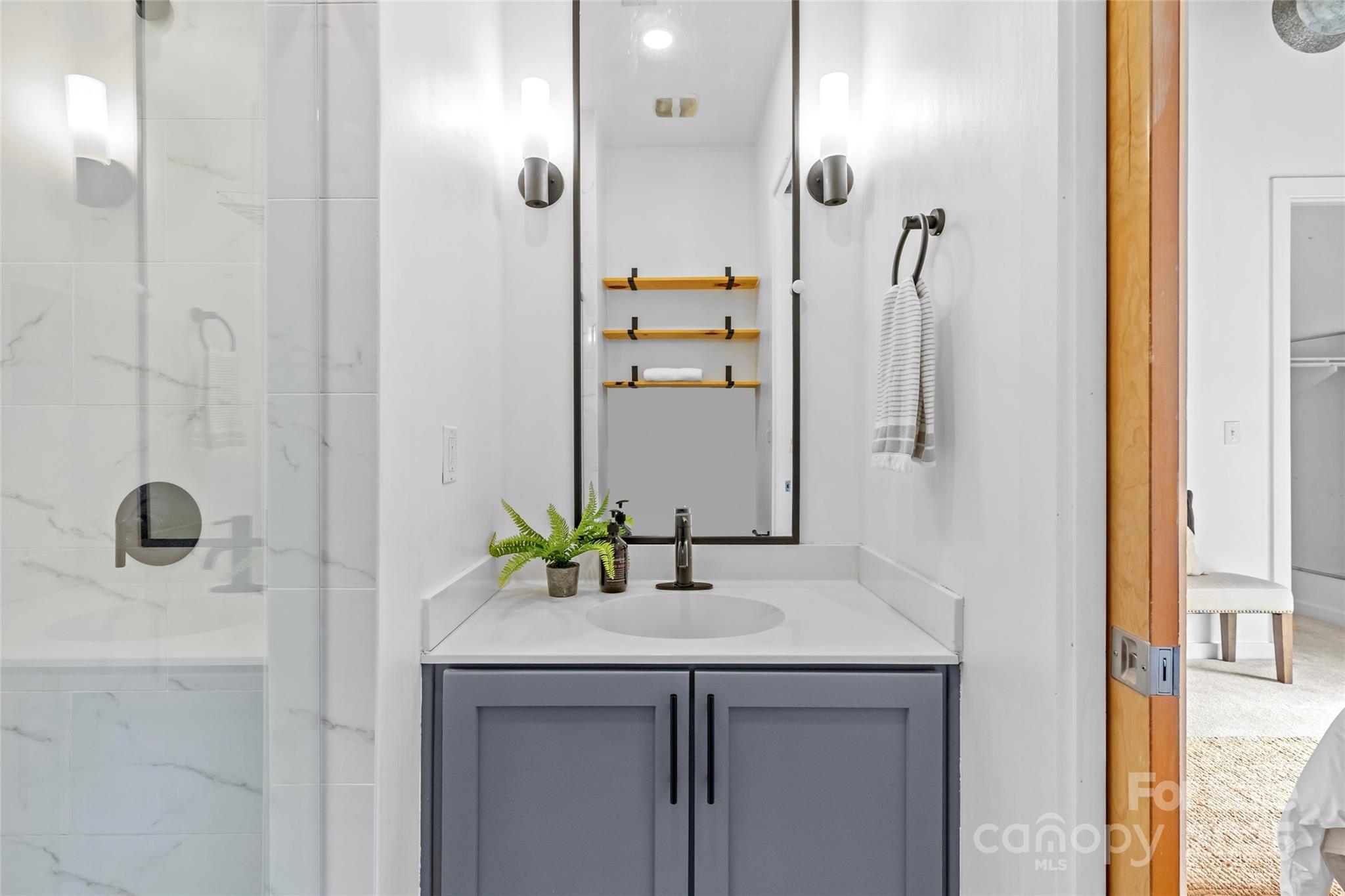 2116 McClintock Road, Unit 232 Charlotte, NC 28205 - Photo 35 of 48 a bathroom with a sink and a mirror