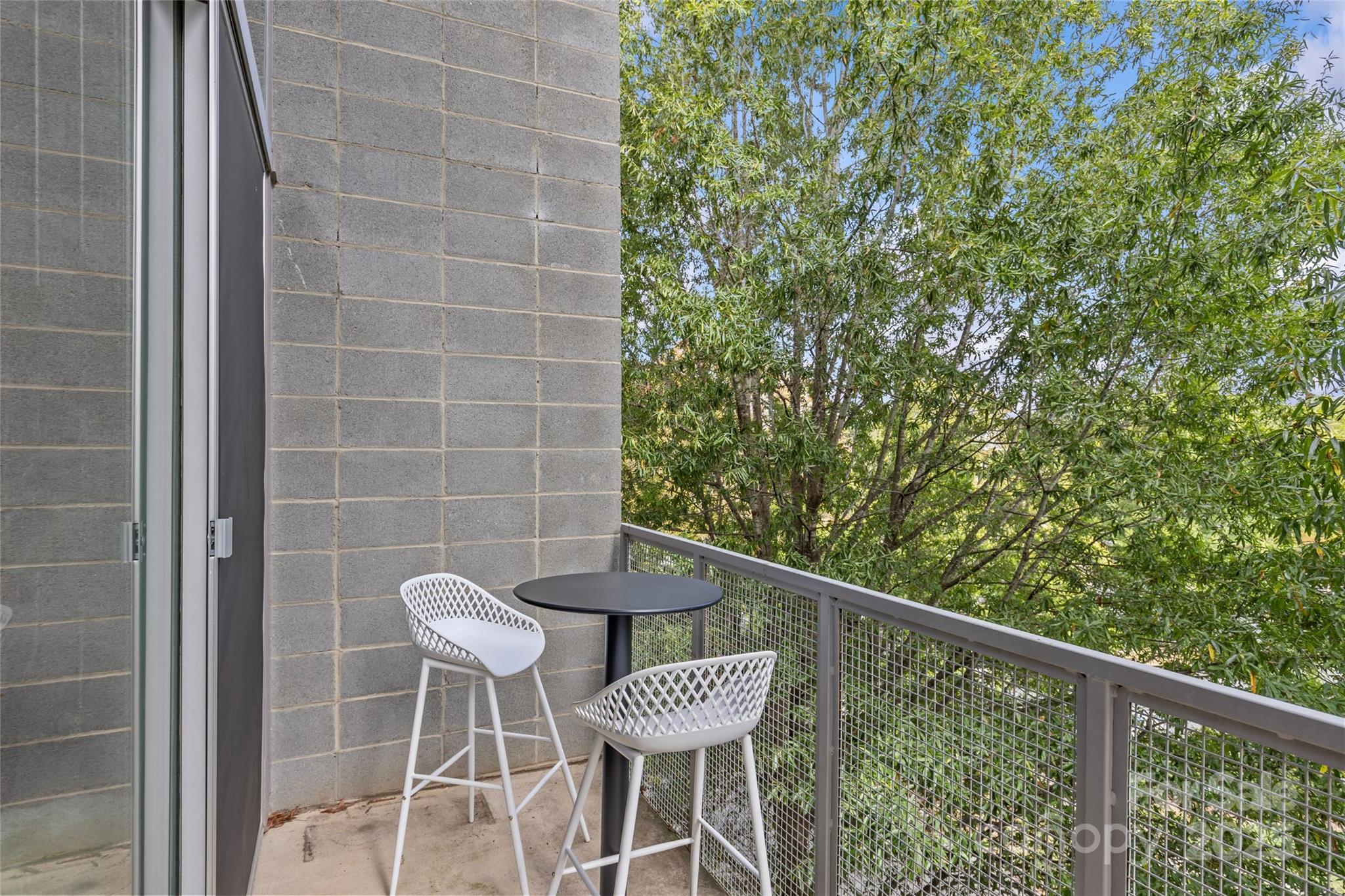 2116 McClintock Road, Unit 232 Charlotte, NC 28205 - Photo 37 of 48 a view of a chair and table in the balcony