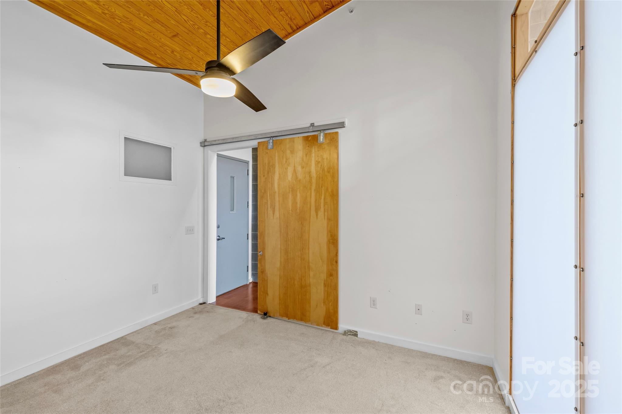 2116 McClintock Road, Unit 232 Charlotte, NC 28205 - Photo 7 of 48 an empty room with a window and a ceiling fan